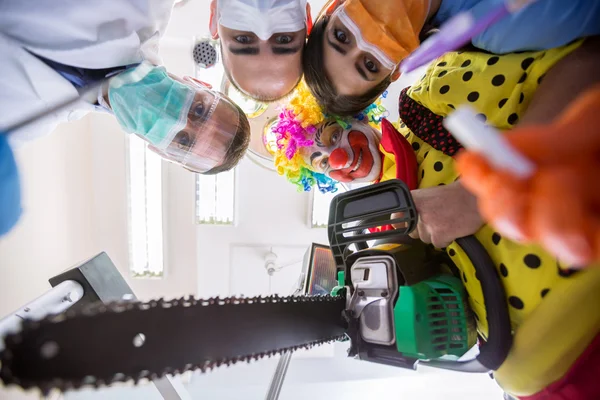 Scary delusion with dental team and clown in bottom view — Stock Photo, Image