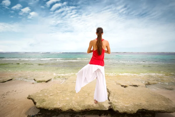 Woman in meditation on rock — Stock Photo, Image