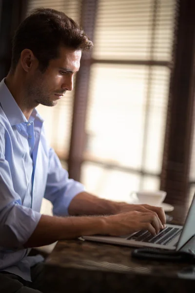 Handsome man typing on laptop — Stock Photo, Image