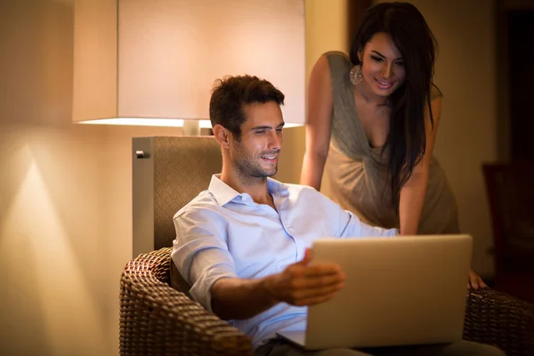 Cheerful couple searching together data on laptop — Stock Photo, Image