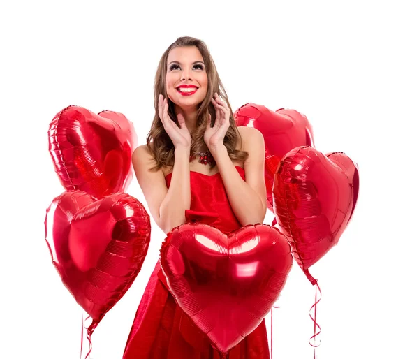 Entzückendes Mädchen umgeben von roten Herzen — Stockfoto