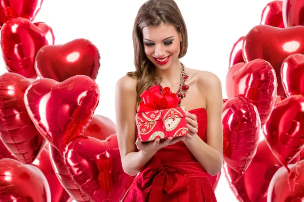 Cute girl peeking behind Valentine's Day balloons — Stock Photo, Image