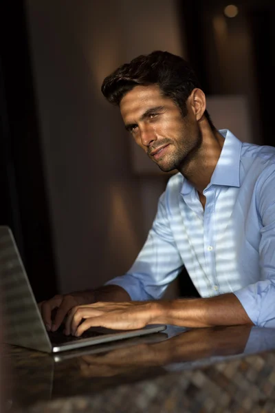 Gutaussehender junger Mann mit Laptop — Stockfoto