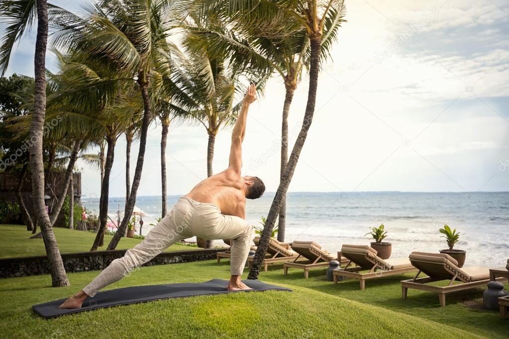 Muscular man doing yoga 