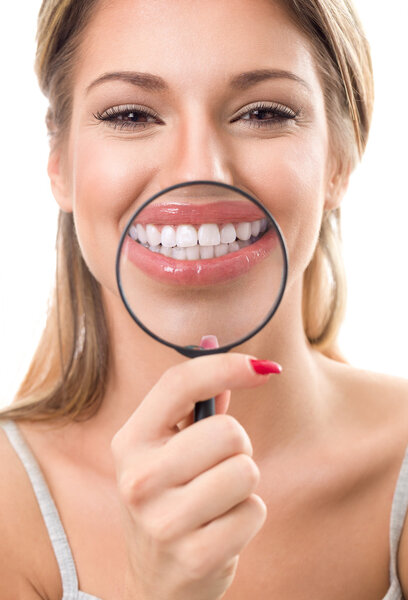 woman with magnifying showing her perfect teeth