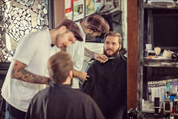 man barber with scissors cut the bear