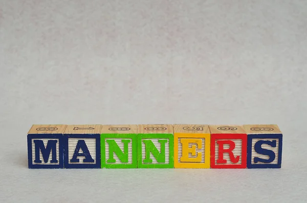 Słowo maniery na biały — Zdjęcie stockowe