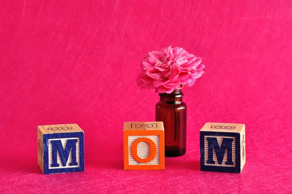 Mama słowo pisane z alfabet bloki na tle różowy, różowy kwiat — Zdjęcie stockowe