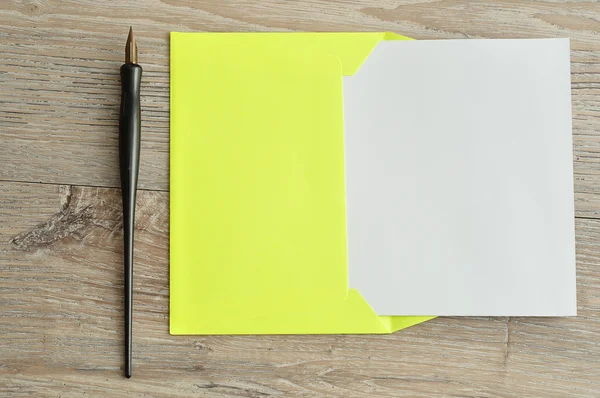 A yellow envelope with a piece of paper sticking out — Stock Photo, Image