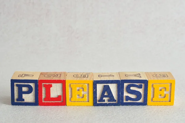 The word please spelled with colorful alphabet blocks — Stock Photo, Image