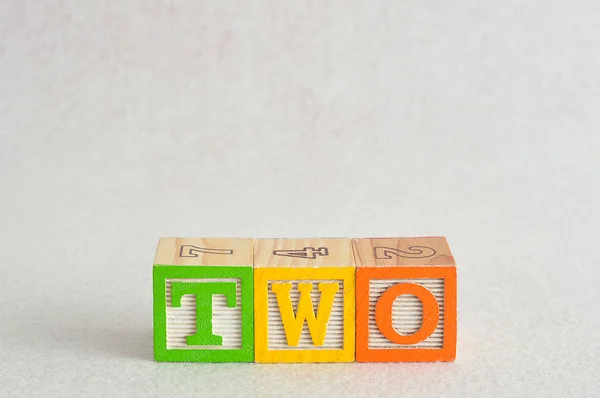 The word two (2) spelled with colorful alphabet blocks — Stock Photo, Image