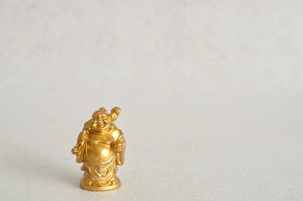 Figurine of a laughing and cheerful golden Buddha — Stock Photo, Image