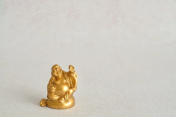 Figurine of a laughing and cheerful golden Buddha — Stock Photo, Image