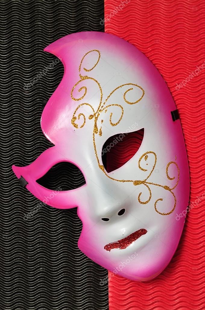 A masquerade mask isolated on a red and black background — Stock Photo © Marietjie 120692332