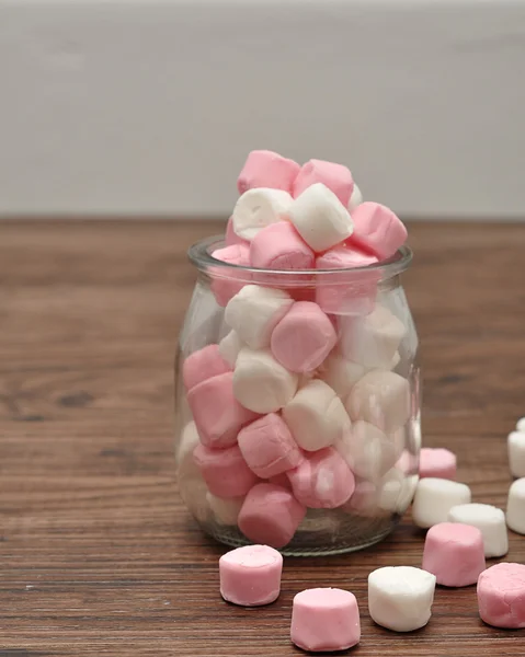 A bottle filled with small pink and white marshmallows — Stock Photo, Image