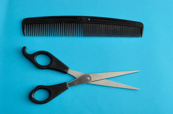 Hair cutting scissors and a comb