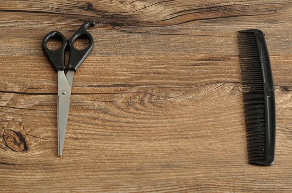 Hair cutting scissors and a comb