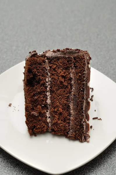 A delicious slice of chocolate cake in a white plate — Stock Photo, Image