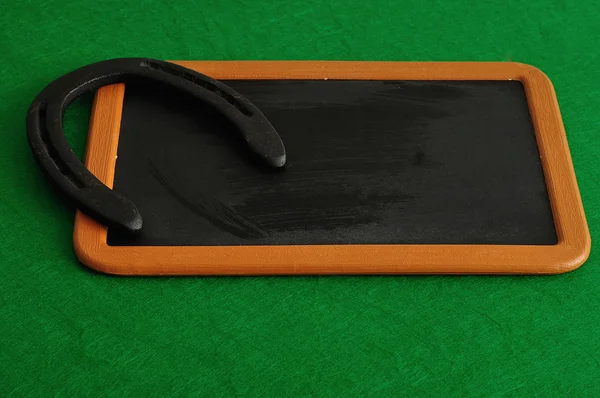 A horse shoe displayed on a black board for St, Patrick's day — Stock Photo, Image