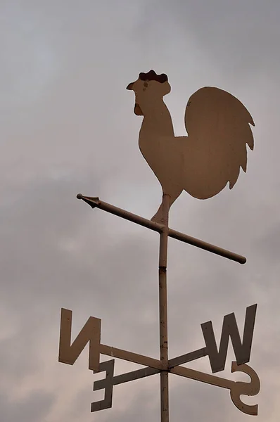 A wind direction indicator with storm clouds in the background