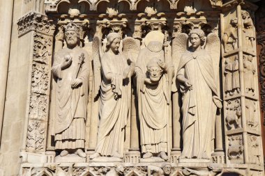 Statue of Saint Denis holding his head, Notre Dame cathedral clipart