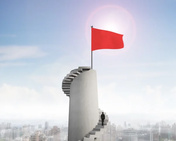 Red wavy flag on tower top with stairs — Stock Photo, Image