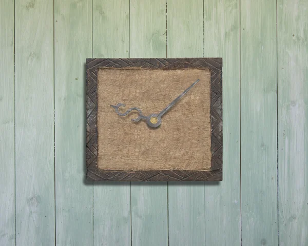 Old wooden board with clock hands