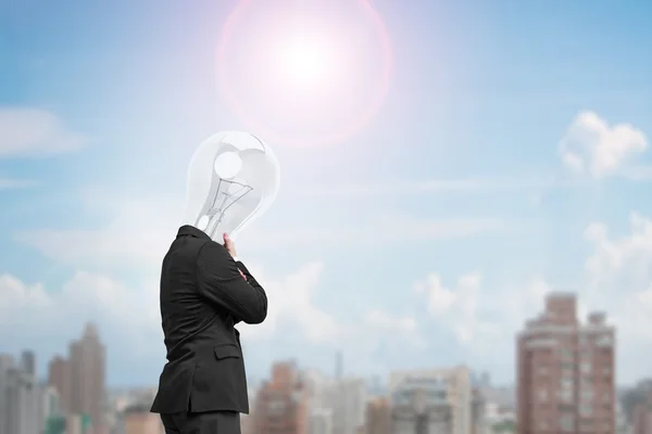 Uomo vista laterale con testa di lampada pensando nella giornata di sole — Foto Stock