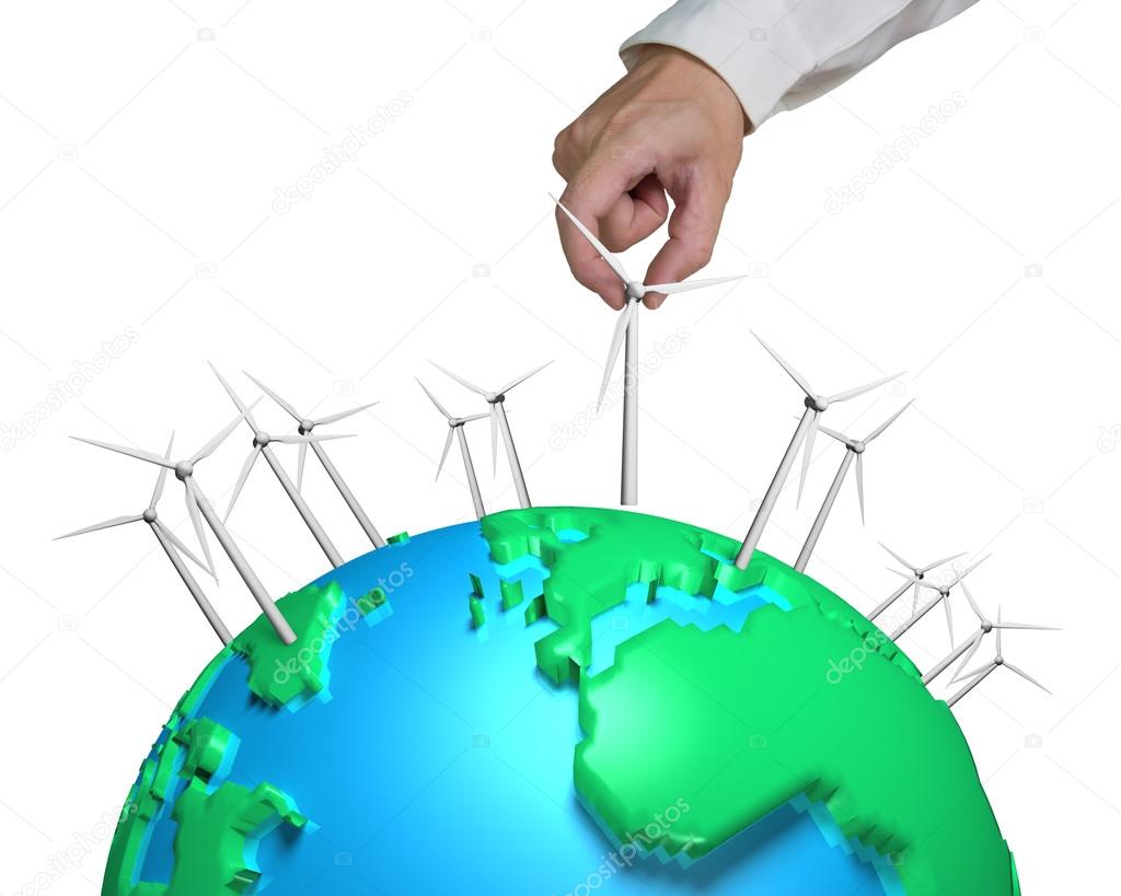 Human hand holding wind turbine on globe