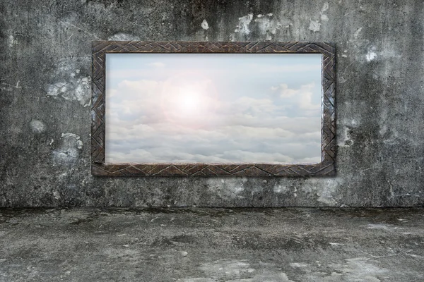 Old wooden frame window on wall with sun clouds sky — Stock Photo, Image