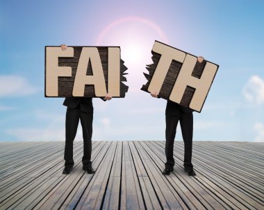 Men holding two cracked FAITH word wooden boards. clipart