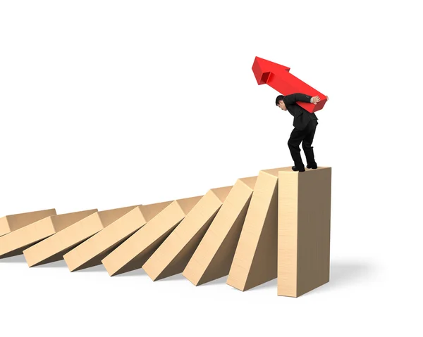 Man carrying arrow symbol standing on falling dominoes — Stock Photo, Image