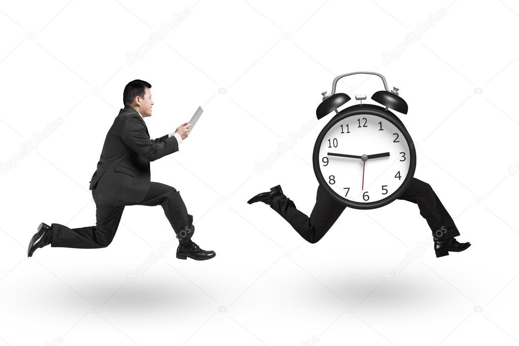 Man using tablet running after alarm clock of running legs