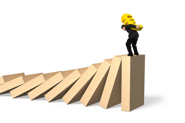 Man carrying Euro symbol standing on falling dominoes — Stock Photo, Image