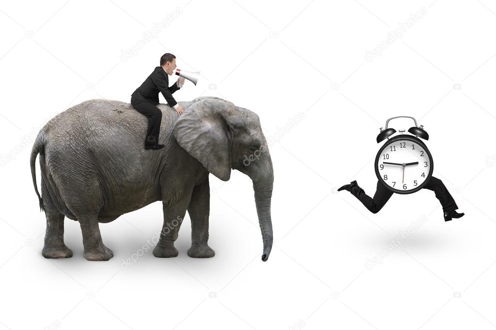 Man using speaker riding elephant after alarm clock