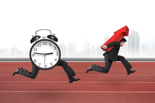 Alarm clock running after man carrying red arrow up — Stock Photo, Image