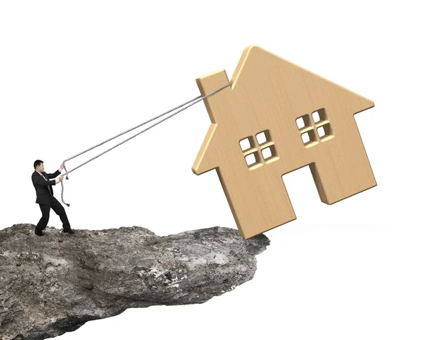 Man pulling rope to move wooden house on cliff edge — Stock Photo, Image