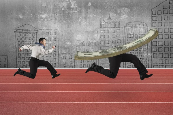 Man running after money with legs — Stock Photo, Image