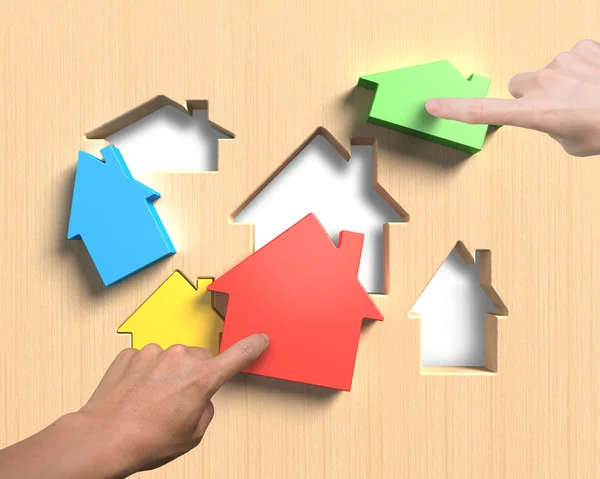 Different houses suit house shape holes board with hands assembl — Stock Photo, Image