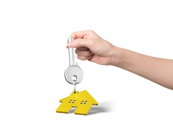 Nő kezében kulcs ház alakú kulcstartó — Stock Fotó