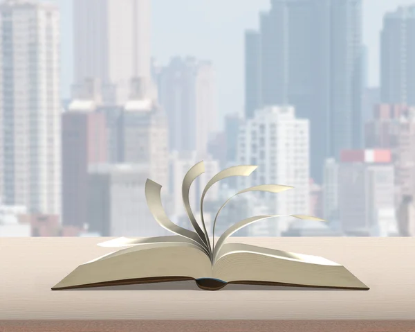 Перелистывание страниц открытой книги на деревянном столе с видом на городское строительство — стоковое фото
