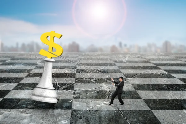 Man pulling dollar sign of money chess on chessboard — Stock Photo, Image