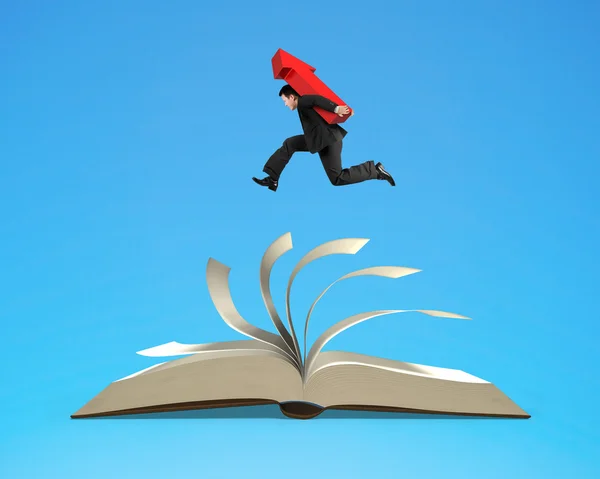 Homem de negócios carregando sinal de seta vermelha correndo em livro aberto — Fotografia de Stock