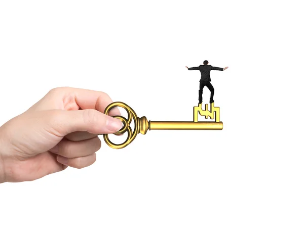 Man balance on treasure key in pound sign shape — Stock Photo, Image