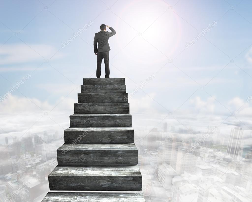 Businessman gazing on top of concrete stairs