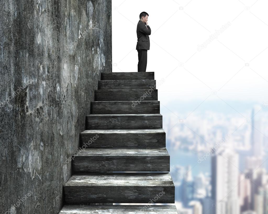 Side view of man standing on top of concrete stairs