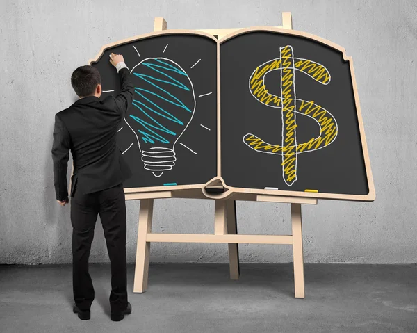 Tekening lamp en geld symbool op blackboard — Stockfoto