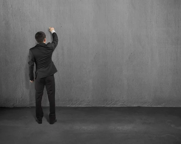 Businessman standing and drawing on wall — Stock Photo, Image