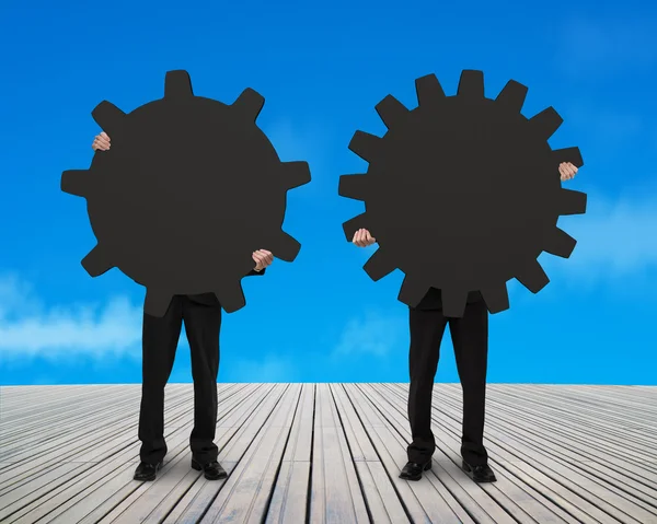 Two men holding their different gear with sky background — Stock Photo, Image