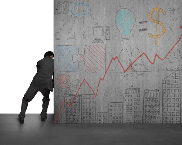 Businessman pushing doodles concrete wall away — Stock Photo, Image